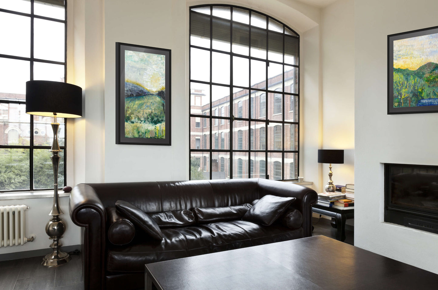 Encaustic art in room with tall windows, leather couch and fireplace